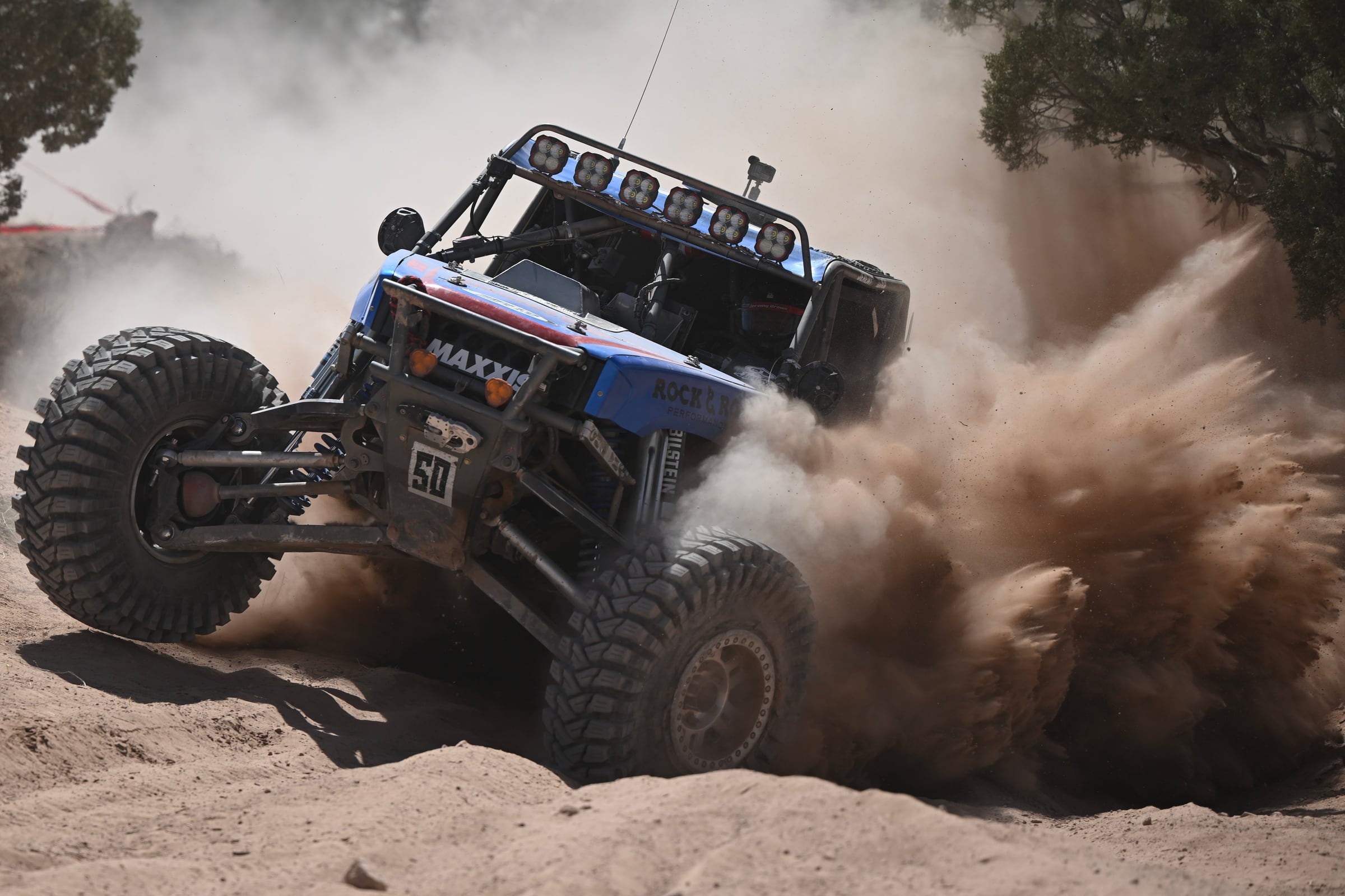 Ultra4 race car throwing a huge rooster tail of sand